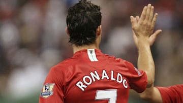 Manchester United's Cristiano Ronaldo (L) high-fives his team mate Carlos Tevez during their match against al Hilal at King Fahed international staduim in Riyadh January 21, 2008. Manchester United are in Riyadh to play against Saudi club Al Hilal in