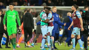 Burnley's Ivorian defender Maxwel Cornet (centre right) celebrates with teammates on the pitch after the English Premier League football match between Burnley and Everton at Turf Moor in Burnley, north west England on April 6, 2022. - Burnley won the