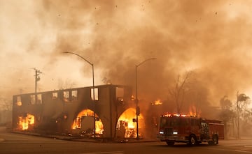 El humo y los escombros llenan el aire mientras una estructura en Lake Avenue.