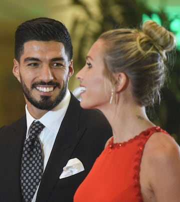 Uruguayan football player Luis Suarez and his wife Sofia Balbi pose on a red carpet during Barcelona's football star Lionel Messi and Antonella Roccuzzo wedding in Rosario, Santa Fe province, Argentina on June 30, 2017.
