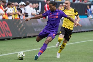 Liverpool's Virgil van Dijk (L) vies for the ball with Borussia Dortmund's Mariuys Wolf (R) during the 2018 International Champions Cup at Bank of America Stadium in Charlotte, North Carolina, on July 22, 2018.  / AFP PHOTO / JIM WATSON