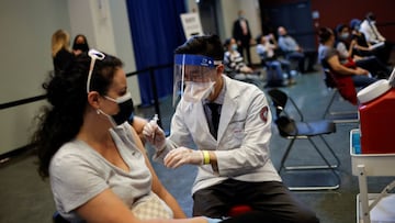 A person receives a dose of the Johnson & Johnson coronavirus disease (COVID-19) vaccine during a visit of U.S. Vice President Kamala Harris to a vaccination center in Chinatown, in Chicago, Illinois, U.S., April 6, 2021. REUTERS/Carlos Barria