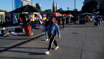 A woman wearing a face mask as a protection against the coronavirus disease (COVID-19) walks outside the Retiro train station, in Buenos Aires, Argentina March 31, 2021. REUTERS/Agustin Marcarian