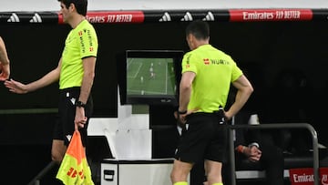 Referee Cesar Soto reviews the video and awards a penalty to Atletico Madrid during the Spanish league football match between Real Madrid CF and Club Atletico de Madrid at Santiago Bernabeu Stadium in Madrid on February 8, 2025. (Photo by JAVIER SORIANO / AFP)