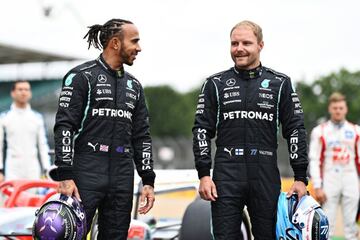 Lewis Hamilton of Great Britain and Mercedes GP and Valtteri Bottas of Finland and Mercedes GP pose for a photo as the prototype for the 2022 F1 season is unveiled during previews ahead of the F1 Grand Prix of Great Britain at Silverstone.