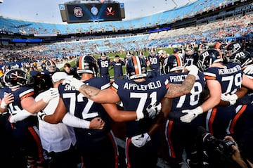 CHARLOTTE, NORTH CAROLINA - DECEMBER 29: Virginia Cavaliers players warm up before their game against the South Carolina Gamecocks in the Belk Bowl at Bank of America Stadium on December 29, 2018 in Charlotte, North Carolina.