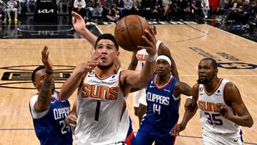 Phoenix Suns guard Devin Booker (1) drives past Los Angeles Clippers guard Norman Powell (24) for a basket in the first half at Crypto.com Arena.