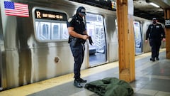 A New York Police Officer of the anti terrorism unit prepares to inspect a jacket left in a train as he patrols the 36th St. subway station, a day after a shooting incident took place in the Brooklyn borough of New York City, U.S., April 13, 2022.  REUTERS/Eduardo Munoz