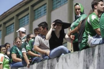 Fans of Brazil's soccer team Chapecoense gather outside the Arena Conda stadium in Chapeco, Brazil, Tuesday, Nov. 29, 2016. A chartered plane that was carrying the Brazilian soccer team to the biggest match of its history crashed into a Colombian hillside and broke into pieces, killing 75 people and leaving six survivors, Colombian officials said Tuesday. (AP Photo/Andre Penner)