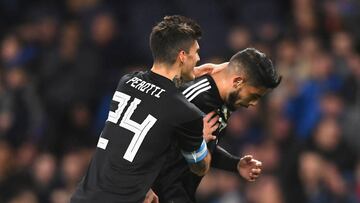 MANCHESTER, ENGLAND - MARCH 23:  Ever Banega of Argentina celebrates with teammate Diego Perotti after scoring his sides first goal during the International friendly match between Italy and Argentina at Etihad Stadium on March 23, 2018 in Manchester, Engl