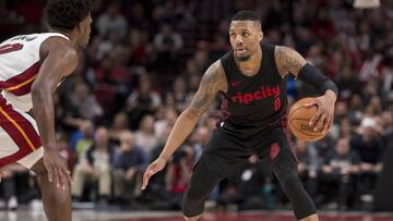 Mar 12, 2018; Portland, OR, USA; Portland Trail Blazers guard Damian Lillard (0) dribbles the ball during the second half against Miami Heat forward Justise Winslow (left) at the Moda Center. The Trail Blazers won 115-99. Mandatory Credit: Troy Wayrynen-USA TODAY Sports