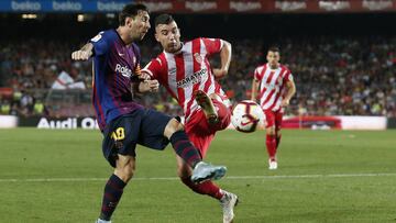 Barcelona's Argentinian forward Lionel Messi (L) vies with Girona's Spanish midfielder Borja Garcia during the Spanish league football match between FC Barcelona and Girona FC at the Camp Nou stadium in Barcelona on September 23, 2018. (Photo by