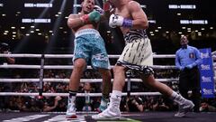 NEW YORK, NEW YORK - JULY 30: Danny Garcia lands a punch on Jose Benavidez Jr. (teal shorts) during their super welterweight boxing match at Barclays Center on July 30, 2022 in in the Brooklyn borough of New York.   Adam Hunger/Getty Images/AFP
== FOR NEWSPAPERS, INTERNET, TELCOS & TELEVISION USE ONLY ==