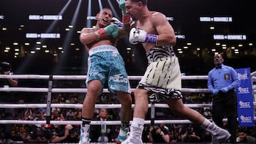 NEW YORK, NEW YORK - JULY 30: Danny Garcia lands a punch on Jose Benavidez Jr. (teal shorts) during their super welterweight boxing match at Barclays Center on July 30, 2022 in in the Brooklyn borough of New York.   Adam Hunger/Getty Images/AFP
== FOR NEWSPAPERS, INTERNET, TELCOS & TELEVISION USE ONLY ==