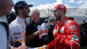 Formula One - F1 - Australian Grand Prix - Melbourne, Australia - 23/03/2017 Red Bull Racing driver Daniel Ricciardo (L) of Australia greets Ferrari driver Sebastian Vettel of Germany during the driver portrait session at the first race of the year.     REUTERS/Jason Reed