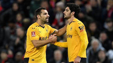 Wolverhampton Wanderers' Portuguese striker Goncalo Guedes (R) celebrates scoring his team's first goal with Wolverhampton Wanderers' Spanish defender Jonny Otto (L) during the English FA Cup third round football match between Liverpool and Wolverhampton Wanderers at Anfield in Liverpool, north-west England on January 7, 2023. (Photo by Oli SCARFF / AFP) / RESTRICTED TO EDITORIAL USE. No use with unauthorized audio, video, data, fixture lists, club/league logos or 'live' services. Online in-match use limited to 120 images. An additional 40 images may be used in extra time. No video emulation. Social media in-match use limited to 120 images. An additional 40 images may be used in extra time. No use in betting publications, games or single club/league/player publications. / 