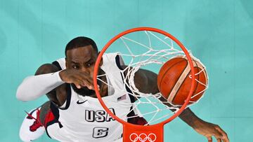 An overview shows USA's #06 LeBron James scores a basket in the men's preliminary round group C basketball match between USA and South Sudan during the Paris 2024 Olympic Games at the Pierre-Mauroy stadium in Villeneuve-d'Ascq, northern France, on July 31, 2024. (Photo by Antonin THUILLIER / POOL / AFP)