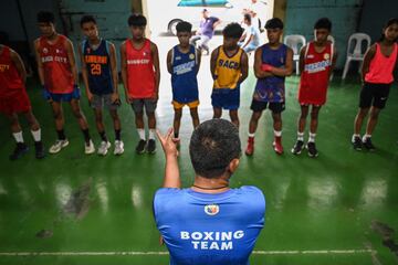 El entrenador Larry Semillano da instrucciones a los j¨®venes en el gimnasio.