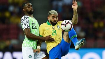 Brazil&#039;s forward Gabriel Barbosa (R) and Nigeria&#039;s defender Adesewo Ajayi fight for the ball during an international friendly football match between Brazil and Nigeria at the National Stadium in Singapore on October 12, 2019. (Photo by Roslan RA