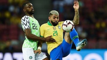 Brazil's forward Gabriel Barbosa (R) and Nigeria's defender Adesewo Ajayi fight for the ball during an international friendly football match between Brazil and Nigeria at the National Stadium in Singapore on October 12, 2019. (Photo by Roslan RA