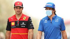 BAHRAIN, BAHRAIN - MARCH 11: Carlos Sainz of Spain and Ferrari and Fernando Alonso of Spain and Alpine F1 walk in the Paddock during Day Two of F1 Testing at Bahrain International Circuit on March 11, 2022 in Bahrain, Bahrain. (Photo by Mark Thompson/Gett