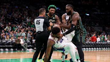 BOSTON, MASSACHUSETTS - OCTOBER 18: Marcus Smart #36 of the Boston Celtics and Joel Embiid #21 of the Philadelphia 76ers are separated by referee Brian Forte #45 during the second half at TD Garden on October 18, 2022 in Boston, Massachusetts. NOTE TO USER: User expressly acknowledges and agrees that, by downloading and or using this photograph, User is consenting to the terms and conditions of the Getty Images License Agreement. Maddie Meyer/Getty Images/AFP