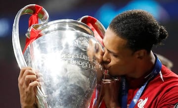 Liverpool's Virgil van Dijk gives the Champions League trophy a kiss