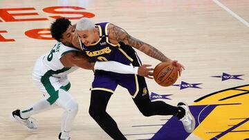 Apr 15, 2021; Los Angeles, California, USA; Los Angeles Lakers forward Kyle Kuzma (0) moves the ball against Boston Celtics guard Marcus Smart (36) during the second half at Staples Center. Mandatory Credit: Gary A. Vasquez-USA TODAY Sports