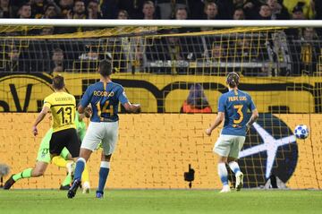 Dortmund defender Raphael Guerreiro, left, scores his sides second goal during the Champions League group A soccer match between Borussia Dortmund and Atletico Madrid at the BVB stadium in Dortmund, Germany, Wednesday, Oct. 24, 2018. (AP Photo/Martin Meissner)