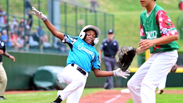 Aug 24, 2023; Williamsport, PA, USA; Caribbean Region player Jayvery Felicia (4) slides to score a run in the fourth inning against the Mexico Region at Lamade Stadium. Mandatory Credit: Evan Habeeb-USA TODAY Sports