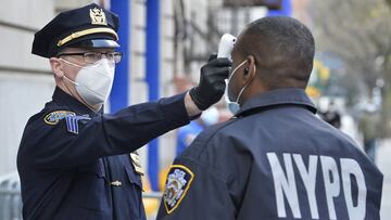 April 15, 2020 - New York, NY USA: NYPD officers are now being tested for symptoms of the corona virus (temperature being taken and a quick set of questions answered on how they feel physically) before they enter the 32 precinct to begin their tour. 250