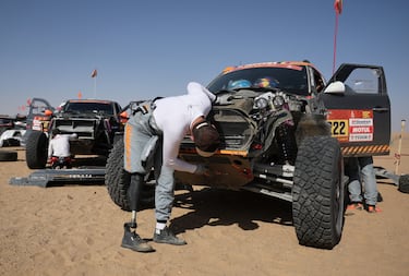 Mathieu Baumel, del equipo X-Raid, repara su coche en el vivac del refugio tras la novena etapa. 