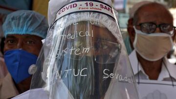 Supporters of Congress party wearing protective gear attend a protest demanding better treatment for people infected with the coronavirus disease and other patients in state government-run hospitals in Kolkata. 