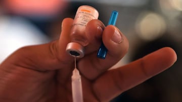 A health worker prepares to inoculate a child with a dose of the CoronaVac vaccine against COVID-19 during a vaccination campaign in San Lorenzo, Paraguay, on January 31, 2022, amid the coronavirus pandemic. - Paraguay began vaccinating children aged five