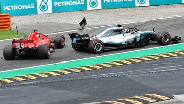 Car parts fly as Mercedes' British driver Lewis Hamilton (R) and Ferrari's German driver Sebastian Vettel crash during the Italian Formula One Grand Prix at the Autodromo Nazionale circuit in Monza on September 2, 2018. (Photo by GIUSEPPE CACACE
