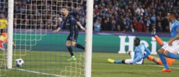 Cristiano Ronaldo slides the ball against the base of the post as Napoli's defence looks on