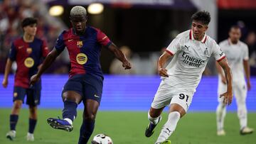 BALTIMORE, MARYLAND - AUGUST 06: Mikfayil Faye of FC Barcelona drives the ball against Hugo Cuenca of AC Milan during a Pre-Season Friendly match between FC Barcelona and AC Milan at M&T Bank Stadium on August 06, 2024 in Baltimore, Maryland. Scott Taetsch/Getty Images/AFP (Photo by Scott Taetsch / GETTY IMAGES NORTH AMERICA / Getty Images via AFP)