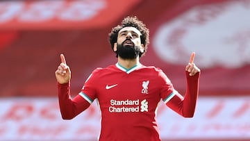 (FILES) In this file photo taken on April 10, 2021 Liverpool's Egyptian midfielder Mohamed Salah celebrates after scoring his team's first goal during the English Premier League football match between Liverpool and Aston Villa at Anfield in Liverpool, north west England. - Mohamed Salah ended speculation over his future by signing a new contract with Liverpool on Friday, July 1, that will reportedly run to 2025. The Egyptian, who has scored 156 goals in 254 appearances for the Reds, had entered the final year of his previous contract. (Photo by Laurence Griffiths / POOL / AFP) / RESTRICTED TO EDITORIAL USE. No use with unauthorized audio, video, data, fixture lists, club/league logos or 'live' services. Online in-match use limited to 120 images. An additional 40 images may be used in extra time. No video emulation. Social media in-match use limited to 120 images. An additional 40 images may be used in extra time. No use in betting publications, games or single club/league/player publications. / 