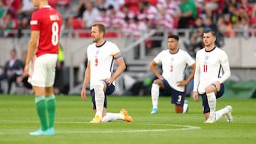 England's Harry Kane, James Justin and Mason Mount take a knee as Hungary's Adam Nagy (left) stands before the UEFA Nations League match at the Puskas Arena, Budapest.