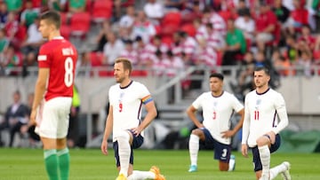 England's Harry Kane, James Justin and Mason Mount take a knee as Hungary's Adam Nagy (left) stands before the UEFA Nations League match at the Puskas Arena, Budapest.