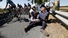 Cycling - Tour de France - Stage 15 - Rodez to Carcassonne - France - July 17, 2022 Police officers remove protestor from the road as riders go by during stage 15 REUTERS/Christian Hartmann