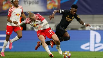 Leipzig's Austrian midfielder #24 Xaver Schlager and Real Madrid's Brazilian forward #07 Vinicius Junior vie for the ball during the UEFA Champions League Round of 16, first-leg football match between RB Leipzig and Real Madrid CF in Leipzig, eastern Germany, on February 13, 2024. (Photo by Odd ANDERSEN / AFP)