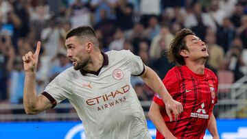 Manchester City's Croatian midfielder #08 Mateo Kovacic (L) celebrates after scoring his team's second goal during the FIFA Club World Cup football semi-final match between England's Manchester City and Japan's Urawa Red Diamonds at King Abdullah Sports City in Jeddah on December 19, 2023. (Photo by Giuseppe CACACE / AFP)