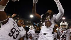 Christian Rorie #93 and Bobby Crosby #27 of the Texas State Bobcats celebrate on the sideline.