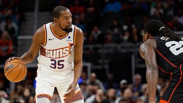 Phoenix Suns forward Kevin Durant (35) dribbles defended by Detroit Pistons center Isaiah Stewart (28) in the first half at Little Caesars Arena.