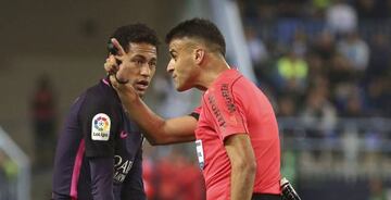 Neymar claims he was only doing his shoe up, but referee Gil Manzano booked him