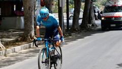 Team Astana's Colombian rider Miguel Angel Lopez holds his leg as he rides before an ambulance of the Italian Red Cross in the first kilometers of the 4th stage of the Giro d'Italia 2022 cycling race, 172 kilometers between Avola and Etna-Nicolosi, Sicily, on May 10, 2022. (Photo by Luca Bettini / AFP) (Photo by LUCA BETTINI/AFP via Getty Images)