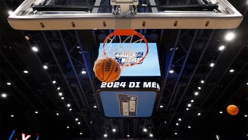 General view of a March Madness basketball falling through the net during NCAA Tournament First Four Practice at UD Arena.