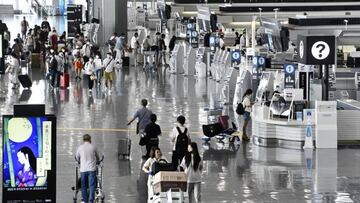 Travelers are seen at the departure lobby for international flights at Narita airport in Chiba Prefecture, near Tokyo, on Aug. 11, 2022, as people head overseas for Japan's "Bon" holidays in the first restriction-free summer since the start of the coronavirus pandemic. (Photo by Kyodo News via Getty Images)