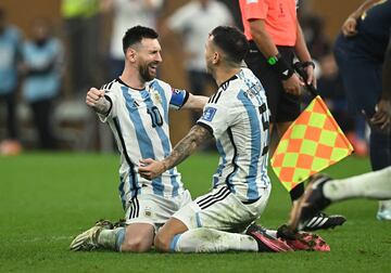 Lionel Messi celebrates with Leandro Paredes after winning the World Cup in a dramatic final game against France.